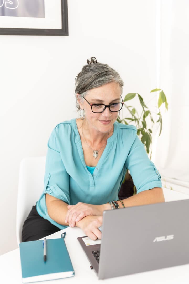 Steph Walker at her laptop in a bright office